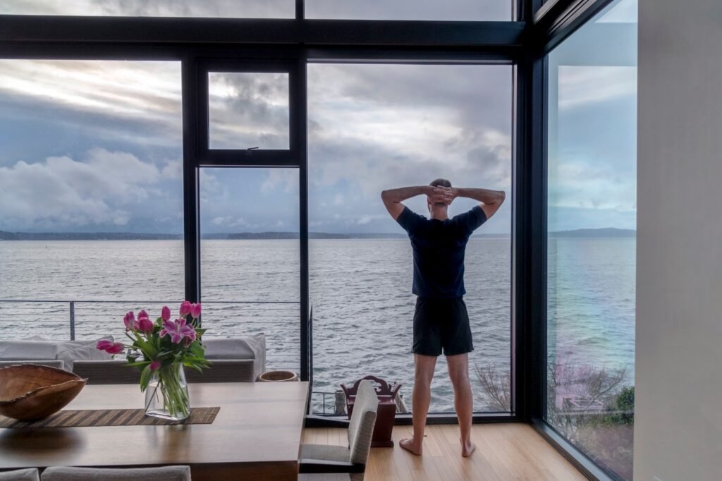 Man looking out modern home window